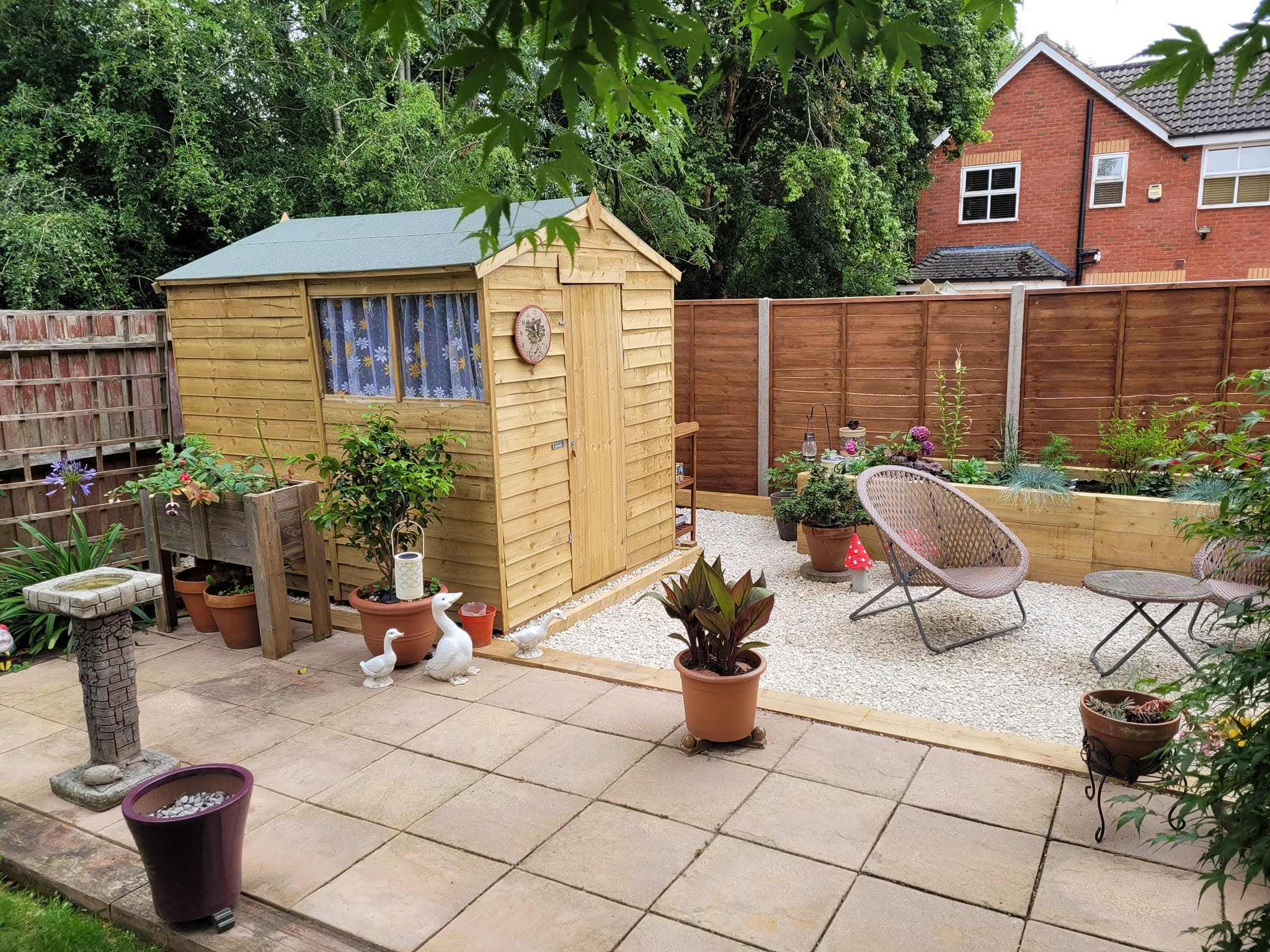 Finished garden with patio, gravel seating area, raised sleeper beds and a shed